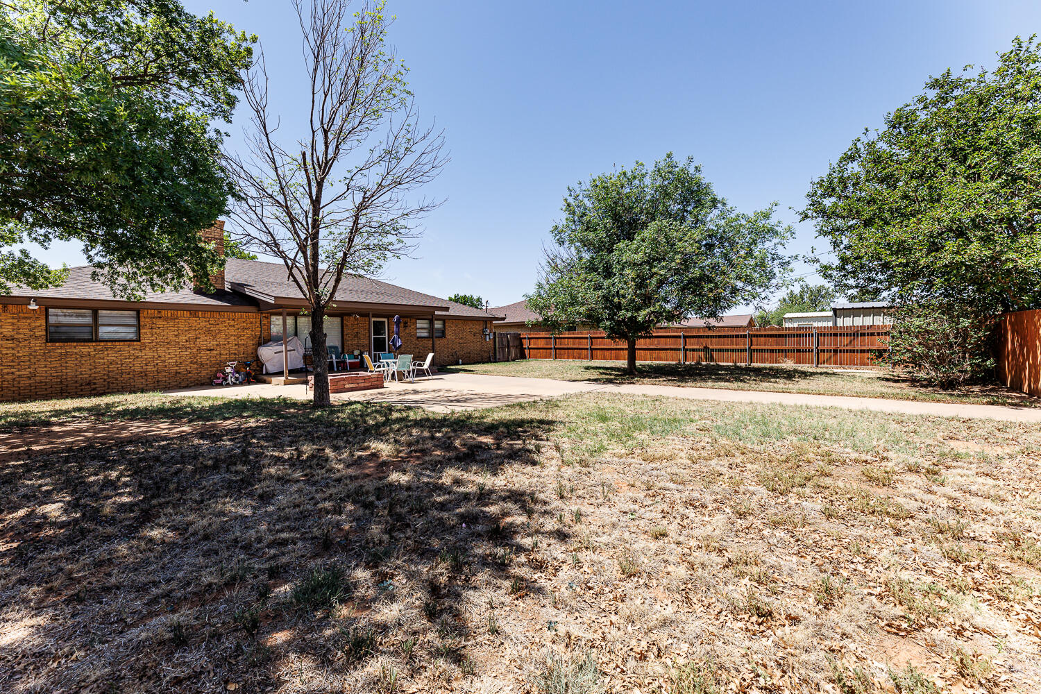 705 Grace Street Brownfield, TX 79316 - Photo 42 of 43 a backyard of a house with lots of green space