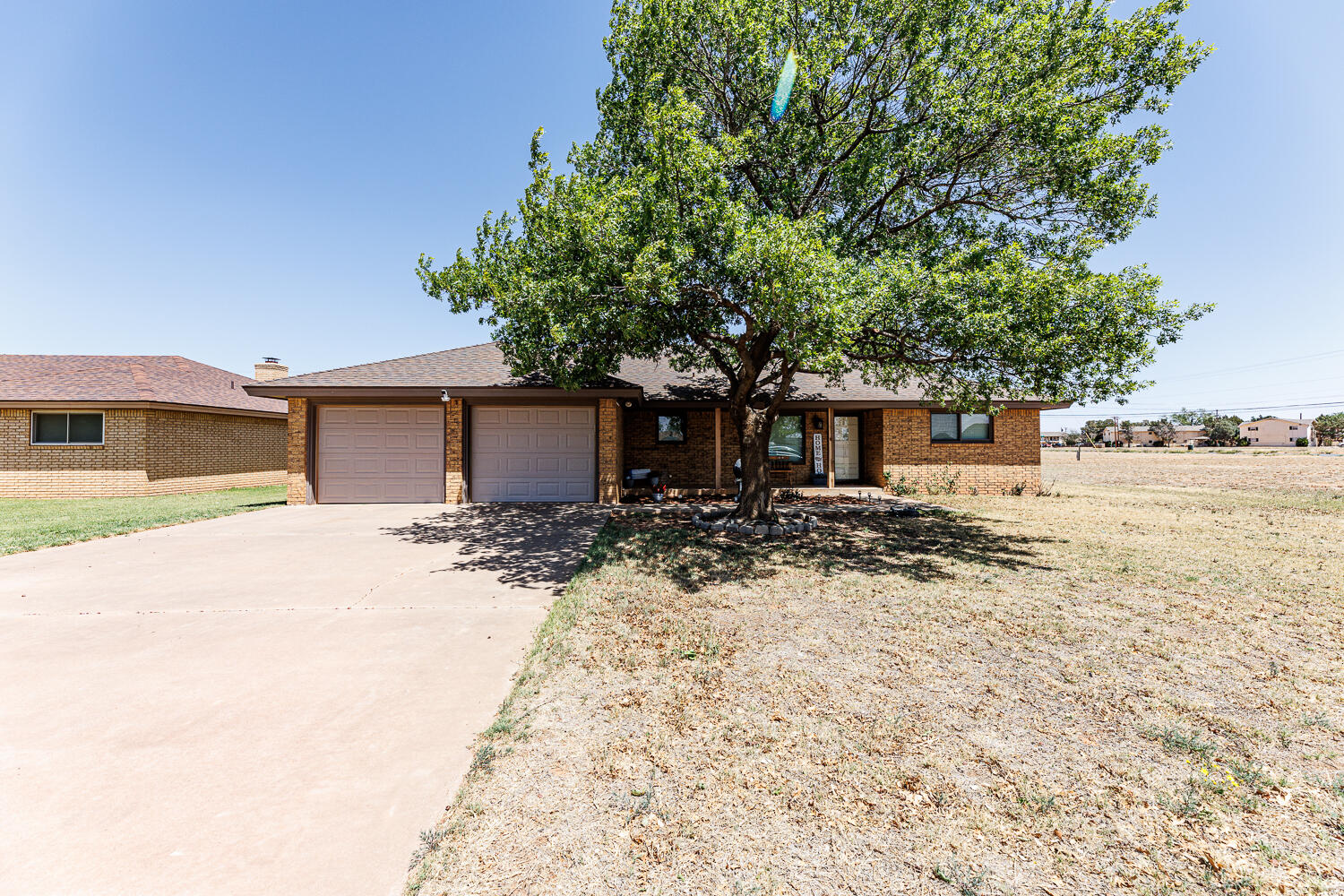 705 Grace Street Brownfield, TX 79316 - Photo 43 of 43 a front view of a house with a yard and garage