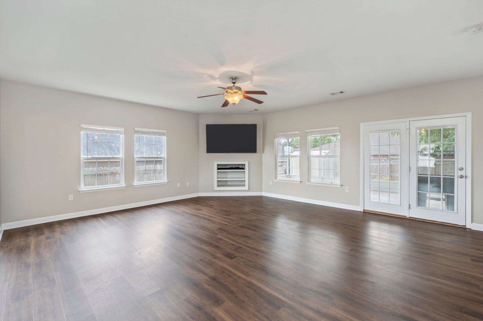4635 Hermosa Road Crestview, FL 32539 - Photo 15 of 49 a view of an empty room with wooden floor and a window