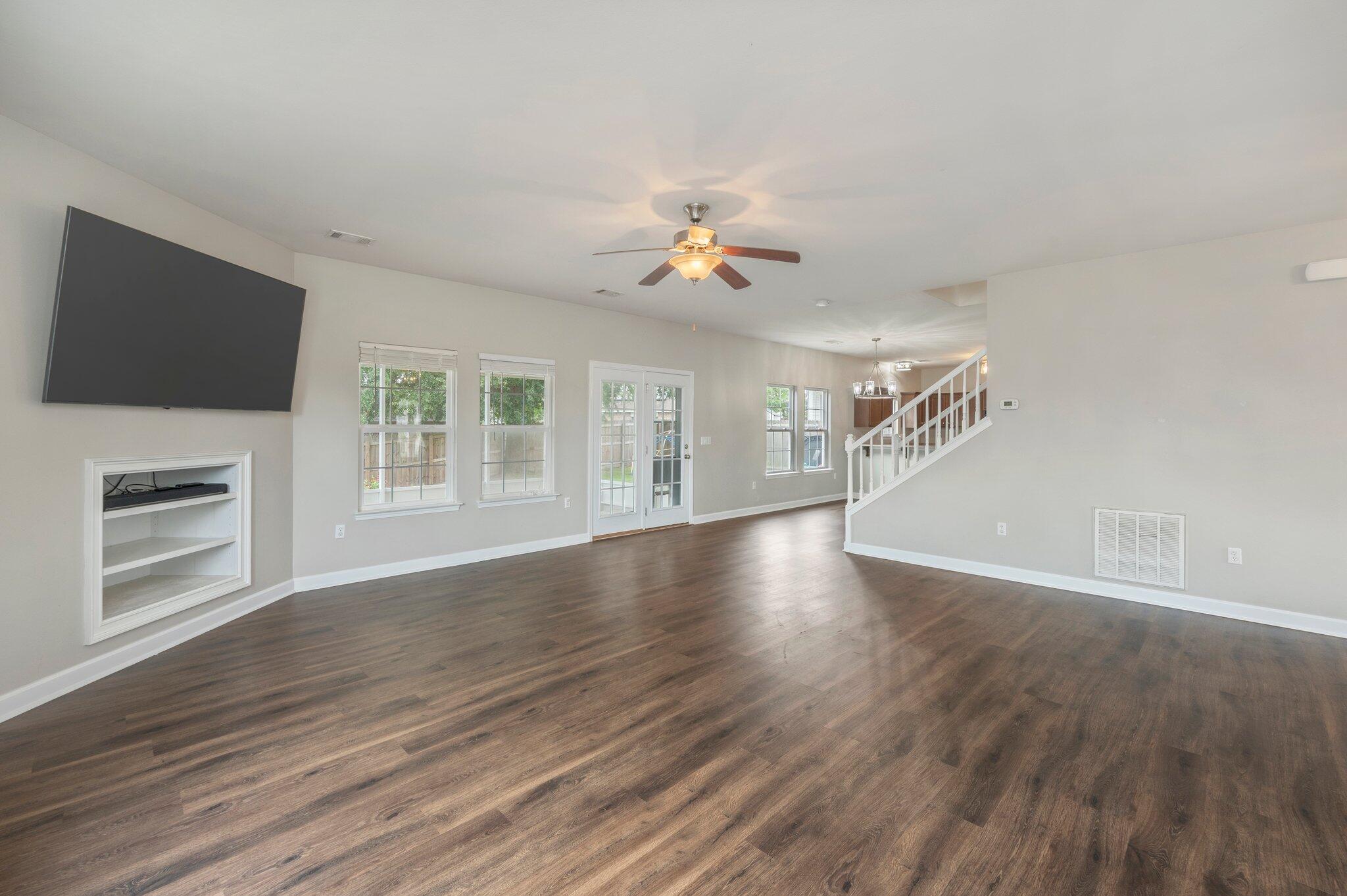 4635 Hermosa Road Crestview, FL 32539 - Photo 16 of 49 a view of an empty room with wooden floor fireplace and a window