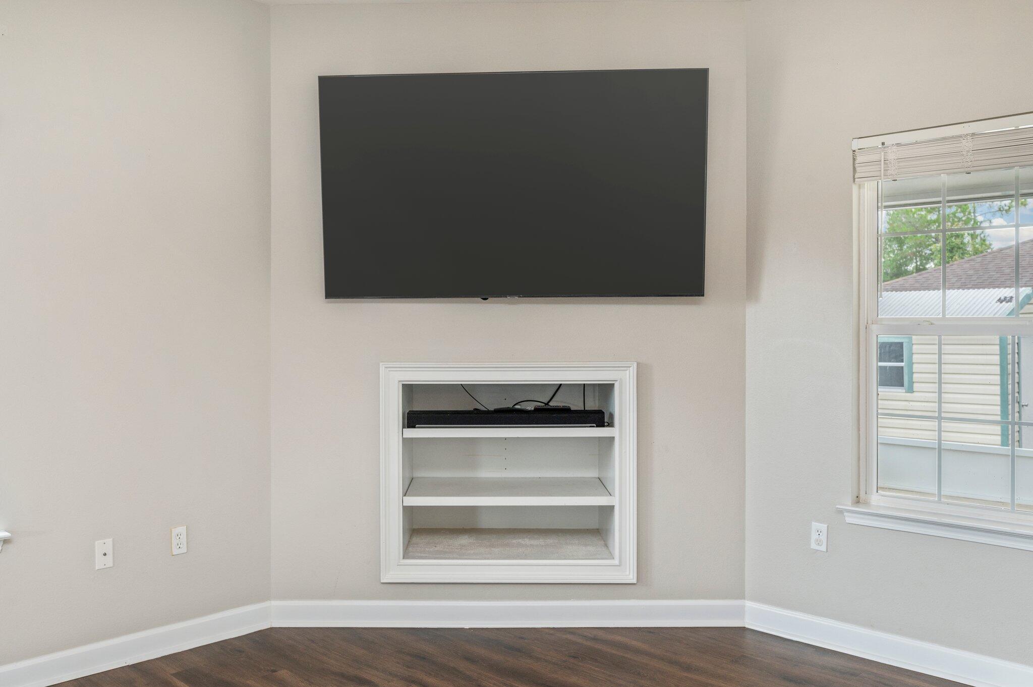 4635 Hermosa Road Crestview, FL 32539 - Photo 18 of 49 a living room with a flat screen tv and a fireplace