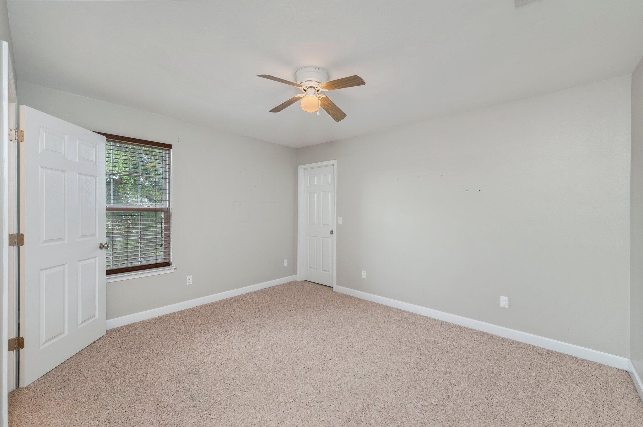 4635 Hermosa Road Crestview, FL 32539 - Photo 22 of 49 an empty room with windows and fan