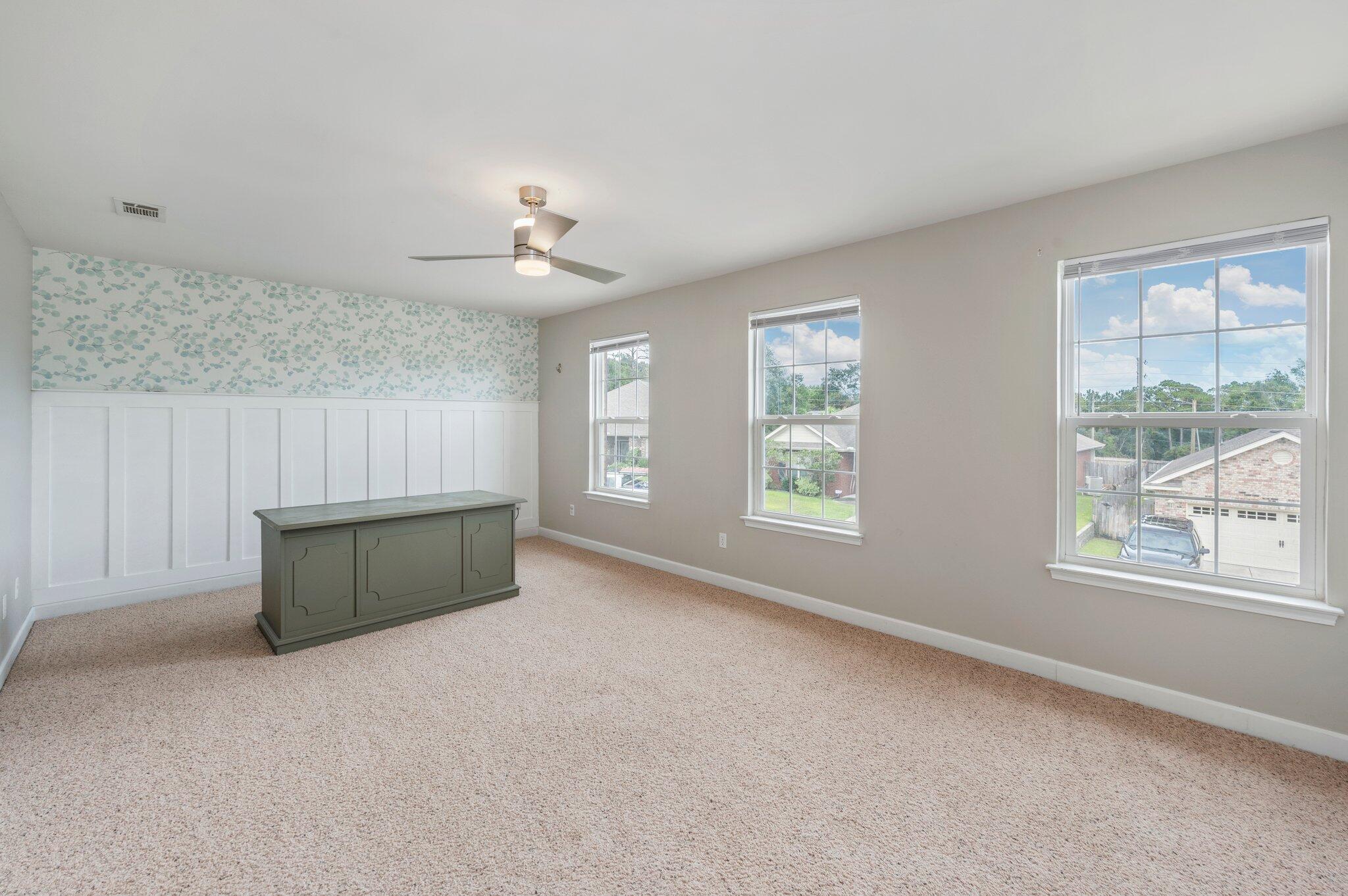 4635 Hermosa Road Crestview, FL 32539 - Photo 25 of 49 an empty room with windows and ceiling fan