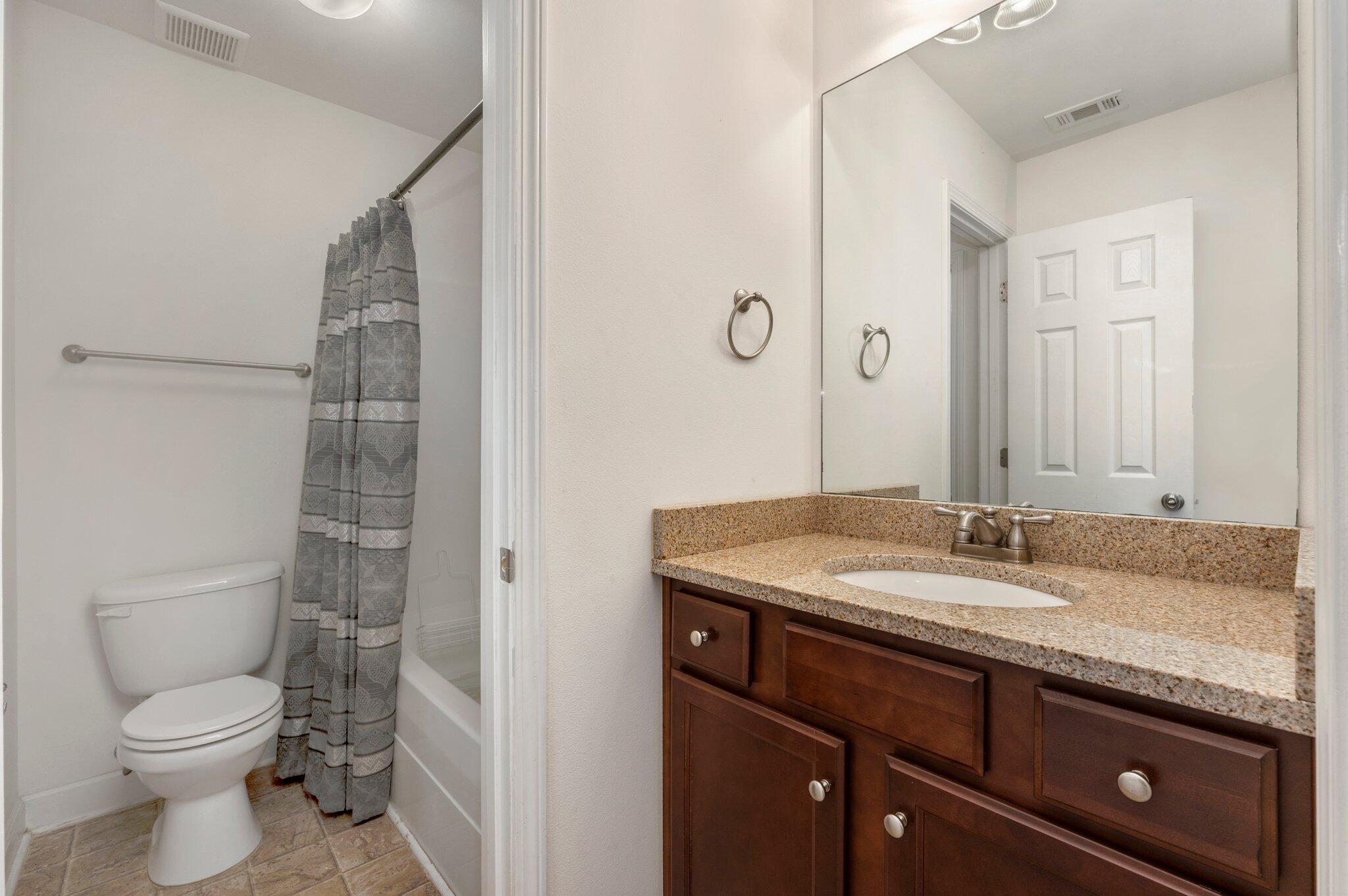 4635 Hermosa Road Crestview, FL 32539 - Photo 29 of 49 a bathroom with a granite countertop sink toilet and shower