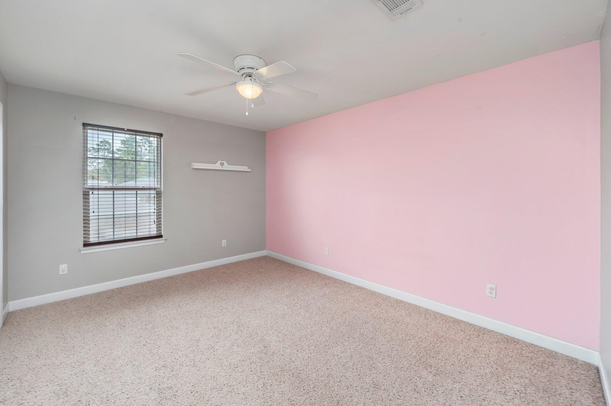 4635 Hermosa Road Crestview, FL 32539 - Photo 30 of 49 an empty room with windows and chandelier fan