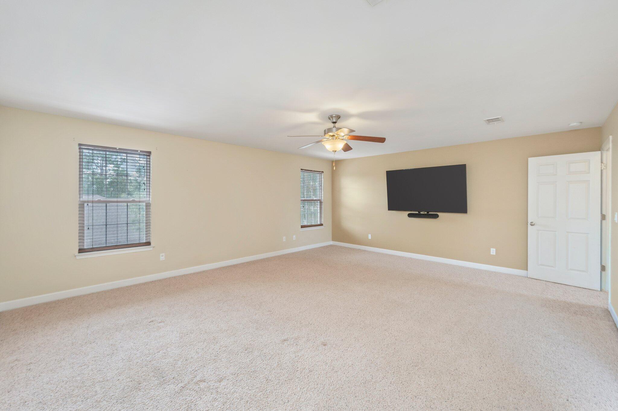 4635 Hermosa Road Crestview, FL 32539 - Photo 33 of 49 a view of an empty room with a window and chandelier fan