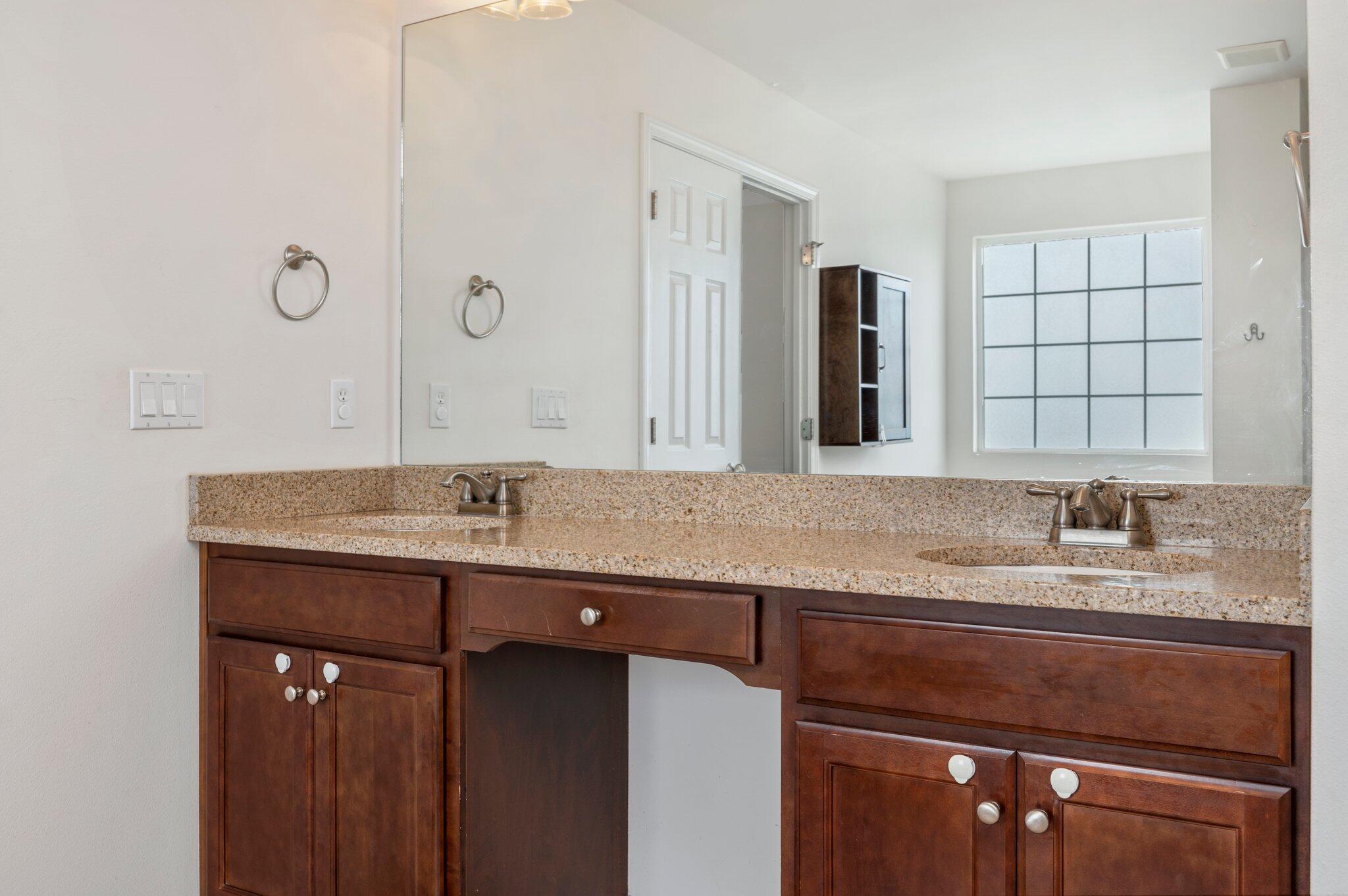4635 Hermosa Road Crestview, FL 32539 - Photo 36 of 49 a bathroom with a granite countertop sink a large mirror and a shower
