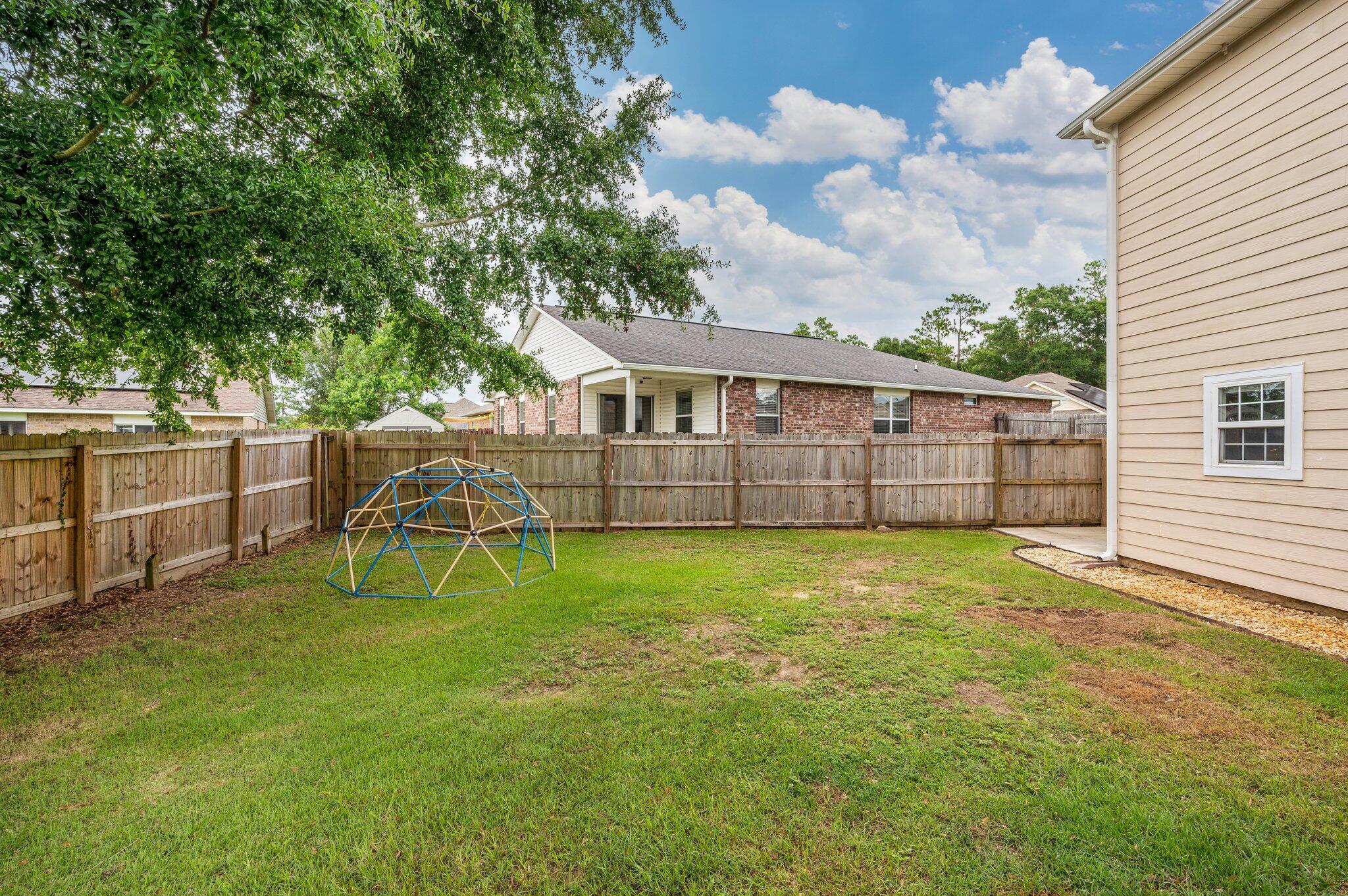 4635 Hermosa Road Crestview, FL 32539 - Photo 46 of 49 a view of a backyard with a garden and plants