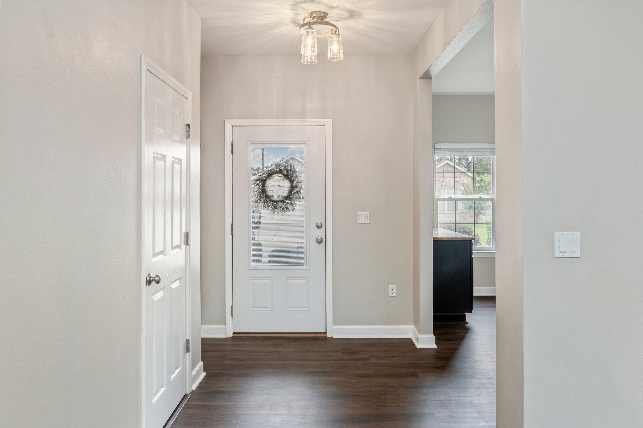 4635 Hermosa Road Crestview, FL 32539 - Photo 5 of 49 a view of a hallway with wooden floor and a living room