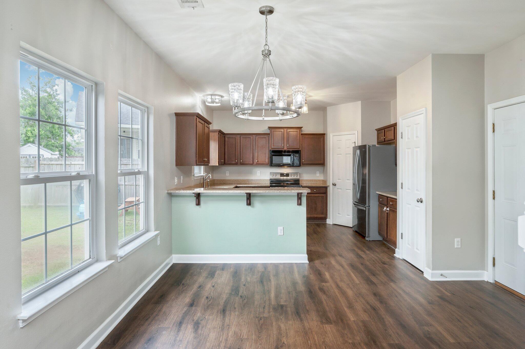 4635 Hermosa Road Crestview, FL 32539 - Photo 7 of 49 a view of a kitchen with refrigerator and wooden floor
