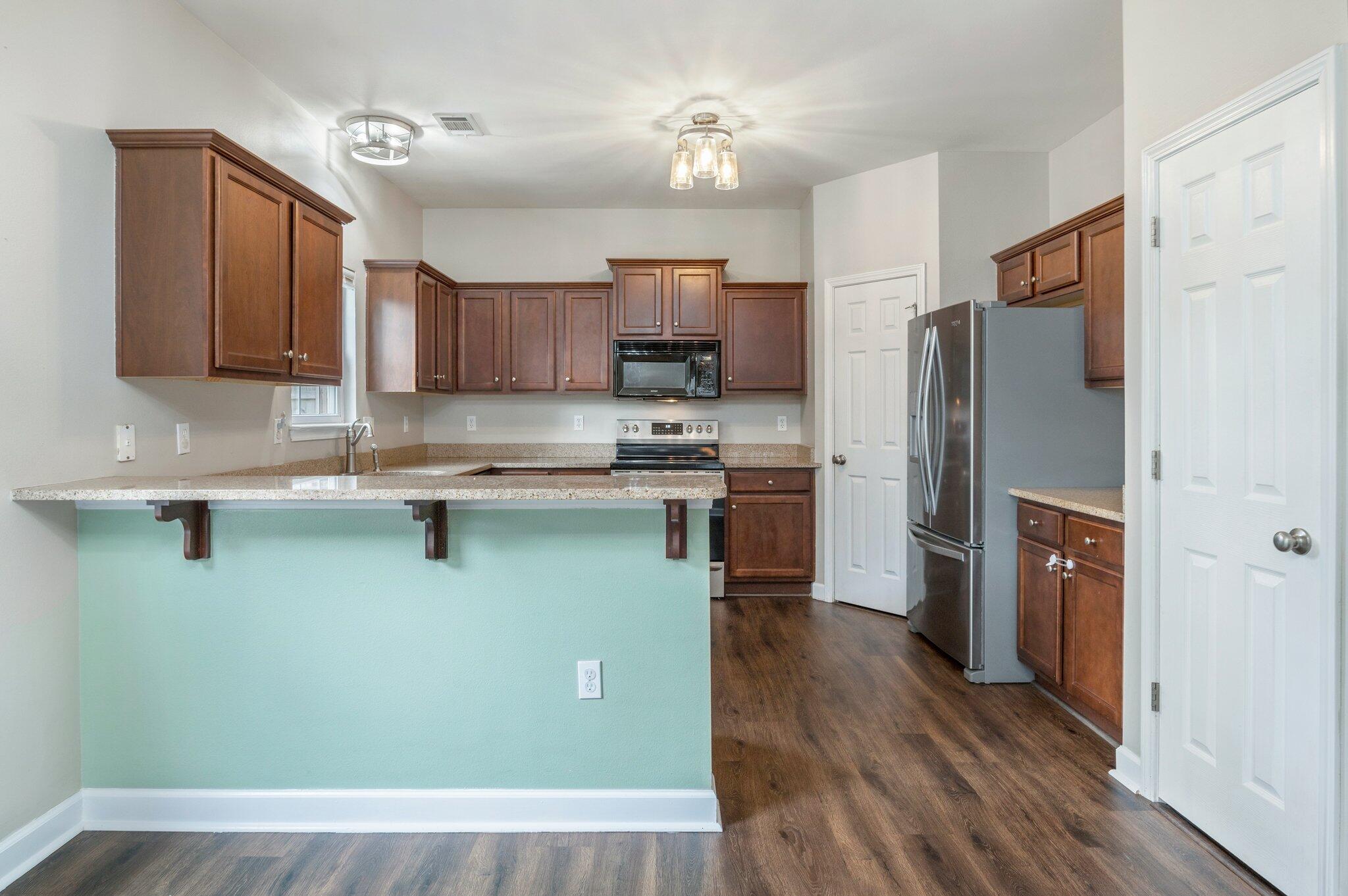 4635 Hermosa Road Crestview, FL 32539 - Photo 8 of 49 a kitchen with stainless steel appliances granite countertop a refrigerator a stove top oven a sink and dishwasher