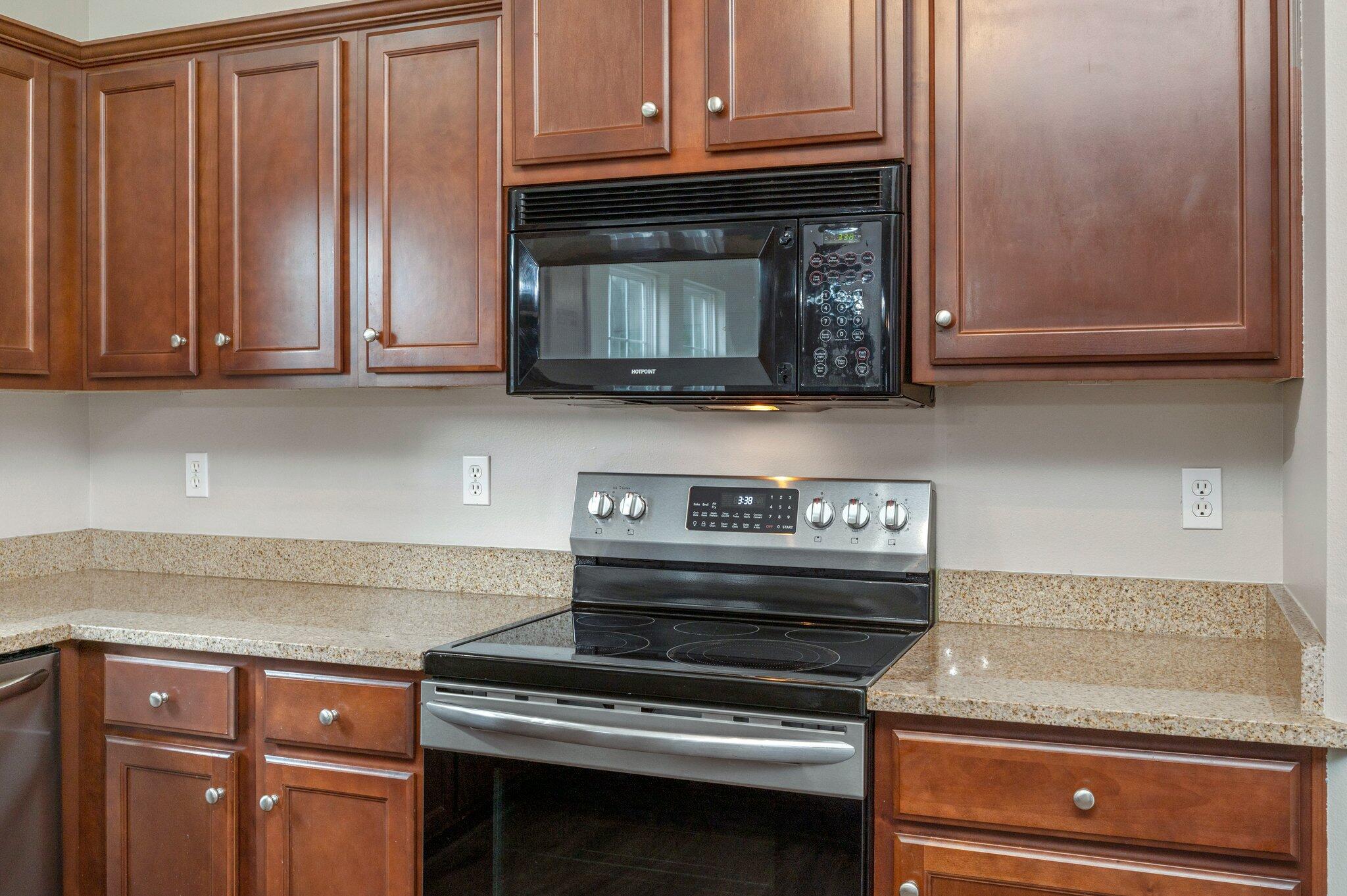 4635 Hermosa Road Crestview, FL 32539 - Photo 10 of 49 a kitchen with wooden cabinets and a stove top oven