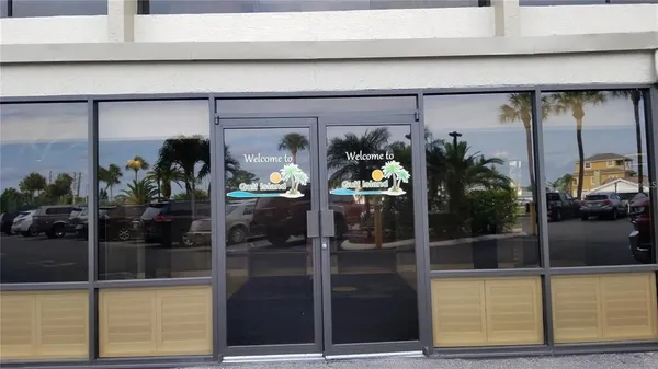 a view of a hallway with a door and a rug