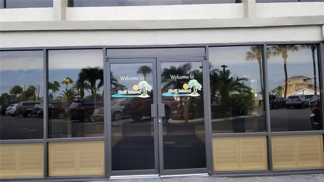 a view of a hallway with a door and a rug