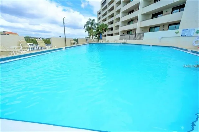 a view of swimming pool with outdoor seating and city view
