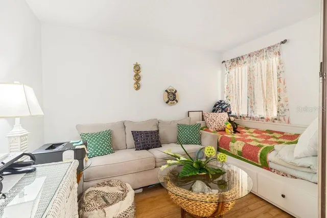 a bedroom with two beds and a large window