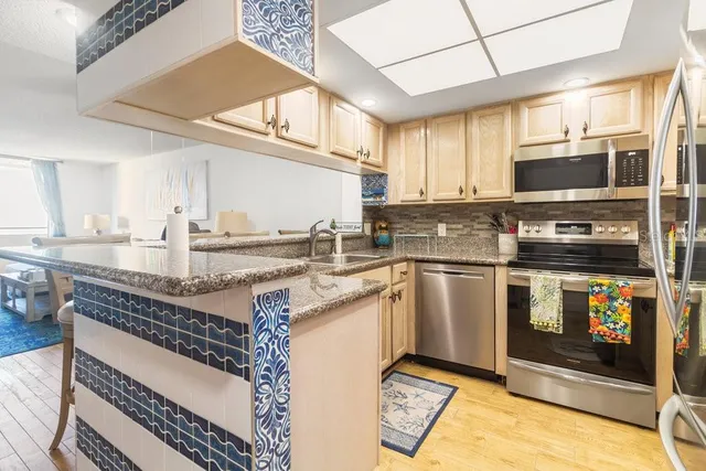 a kitchen with a sink appliances and cabinets