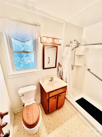 a bathroom with a sink a toilet and a mirror