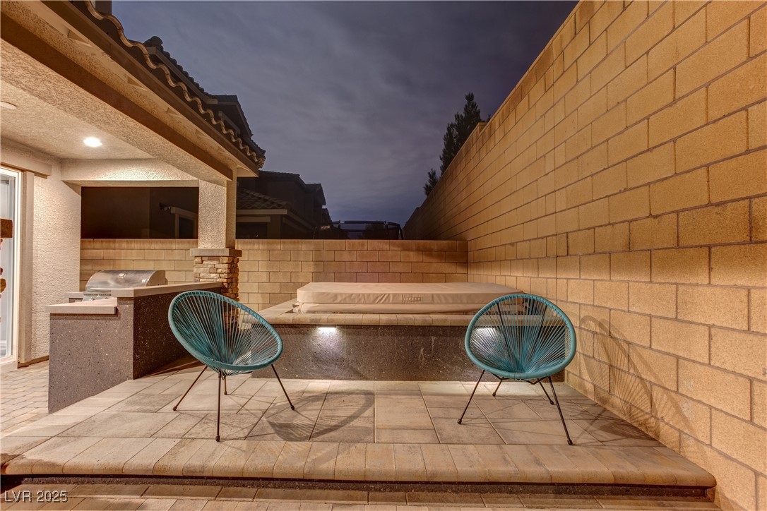 8099 Rams Collide Street Las Vegas, NV 89166 - Photo 13 of 72 Patio at twilight with exterior kitchen and a patio