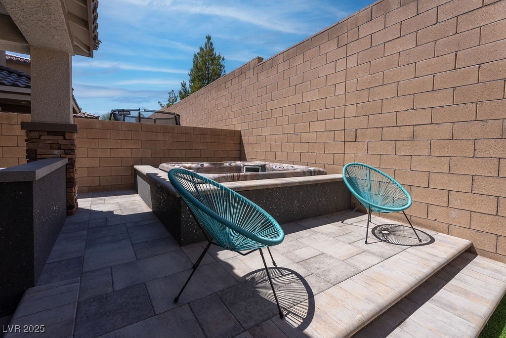 8099 Rams Collide Street Las Vegas, NV 89166 - Photo 14 of 72 Fenced backyard featuring a hot tub and a patio area