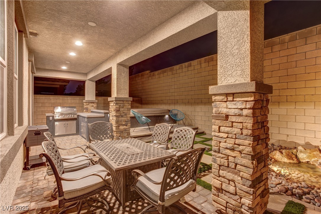 8099 Rams Collide Street Las Vegas, NV 89166 - Photo 15 of 72 View of patio / terrace with an outdoor kitchen and outdoor dining space