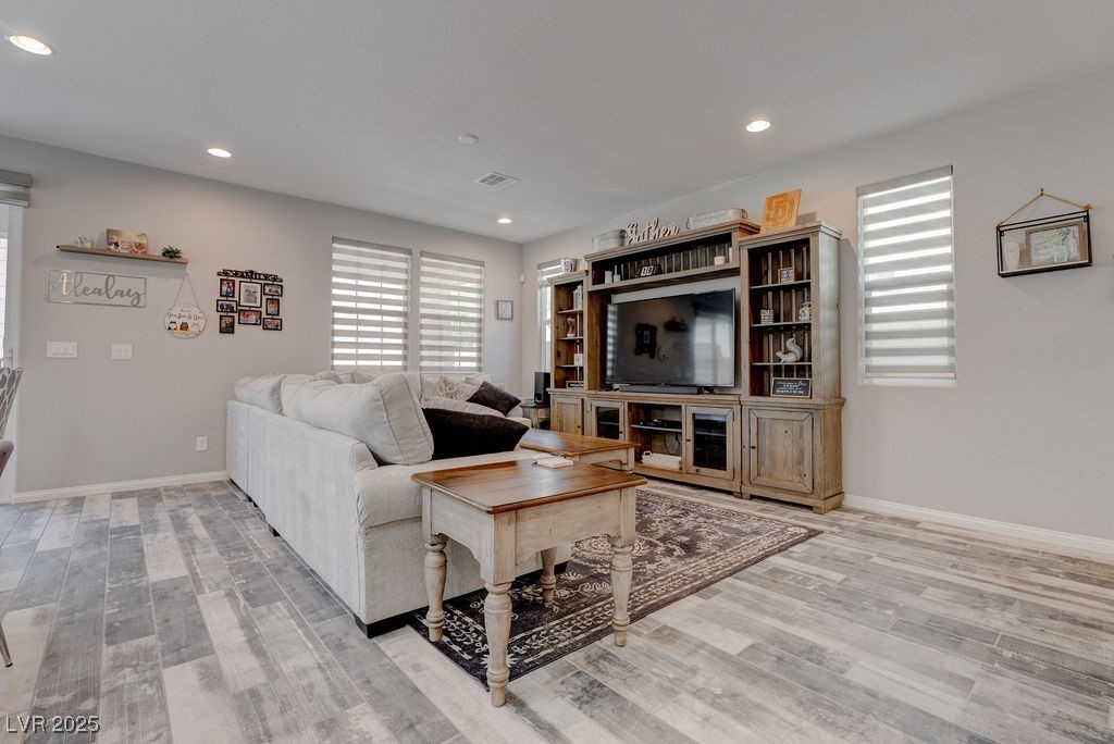 8099 Rams Collide Street Las Vegas, NV 89166 - Photo 19 of 72 Living room with healthy amount of natural light, recessed lighting, and light wood-type flooring