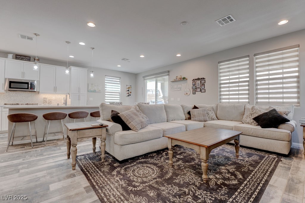 8099 Rams Collide Street Las Vegas, NV 89166 - Photo 20 of 72 Living area featuring recessed lighting and light wood-type flooring