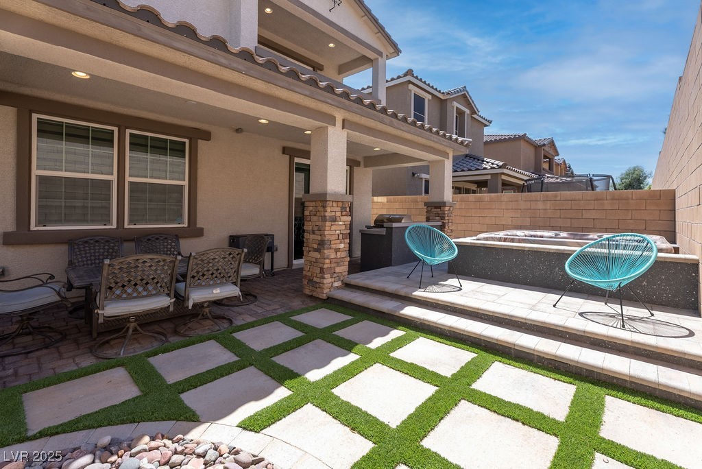 8099 Rams Collide Street Las Vegas, NV 89166 - Photo 21 of 72 View of patio with turf and tile integrated landscaping
