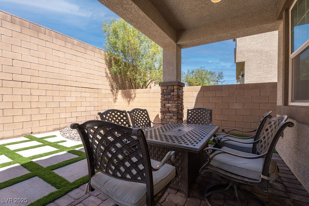 8099 Rams Collide Street Las Vegas, NV 89166 - Photo 28 of 72 Fenced backyard with a patio and outdoor dining space