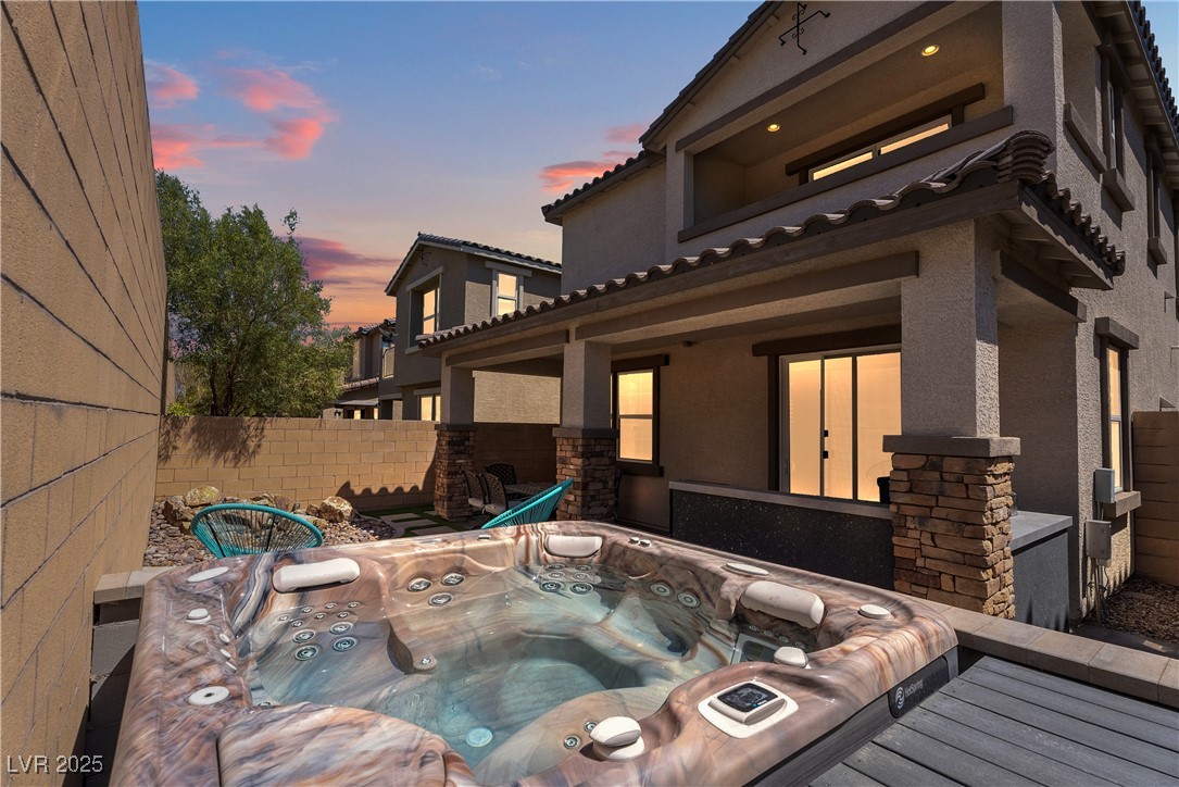 8099 Rams Collide Street Las Vegas, NV 89166 - Photo 3 of 72 Patio terrace at dusk with an outdoor hot tub and a patio