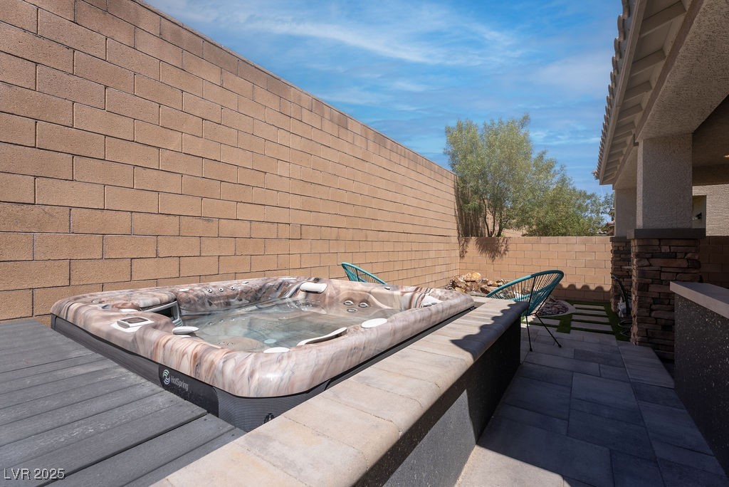 8099 Rams Collide Street Las Vegas, NV 89166 - Photo 31 of 72 Fenced backyard with an outdoor hot tub and a patio