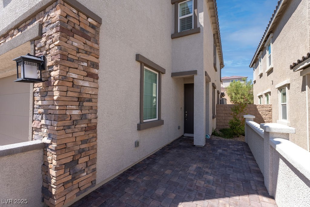8099 Rams Collide Street Las Vegas, NV 89166 - Photo 32 of 72 View of property exterior with stucco siding