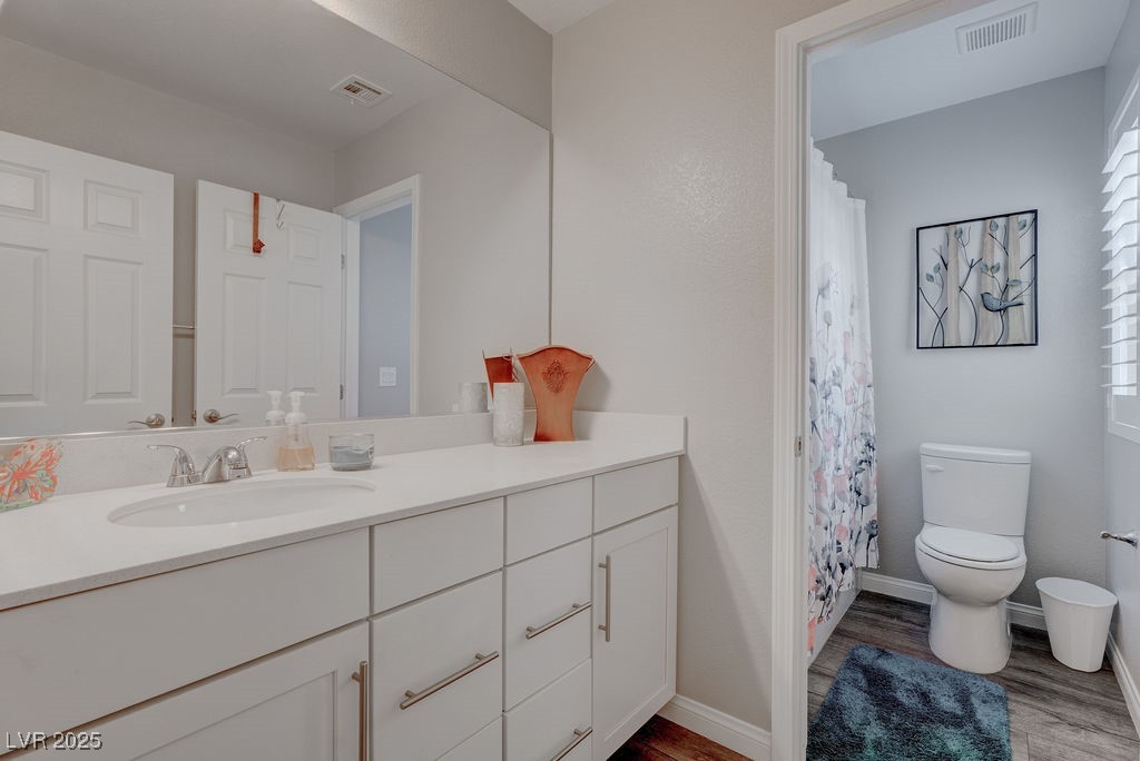 8099 Rams Collide Street Las Vegas, NV 89166 - Photo 37 of 72 Full bath featuring vanity, light wood-style flooring, and a shower with curtain