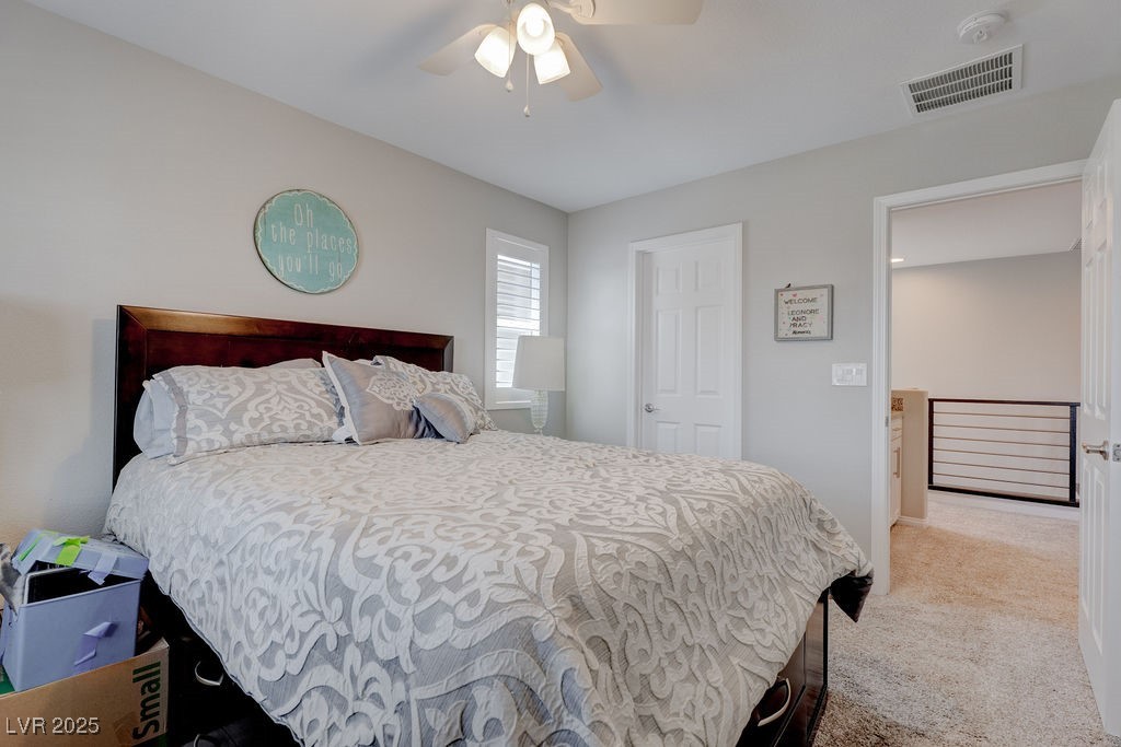 8099 Rams Collide Street Las Vegas, NV 89166 - Photo 41 of 72 Bedroom featuring light colored carpet and ceiling fan