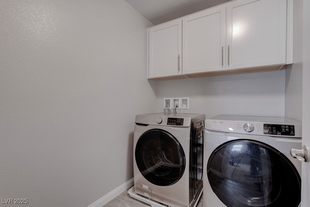 8099 Rams Collide Street Las Vegas, NV 89166 - Photo 47 of 72 Laundry area with washer and clothes dryer and cabinet space