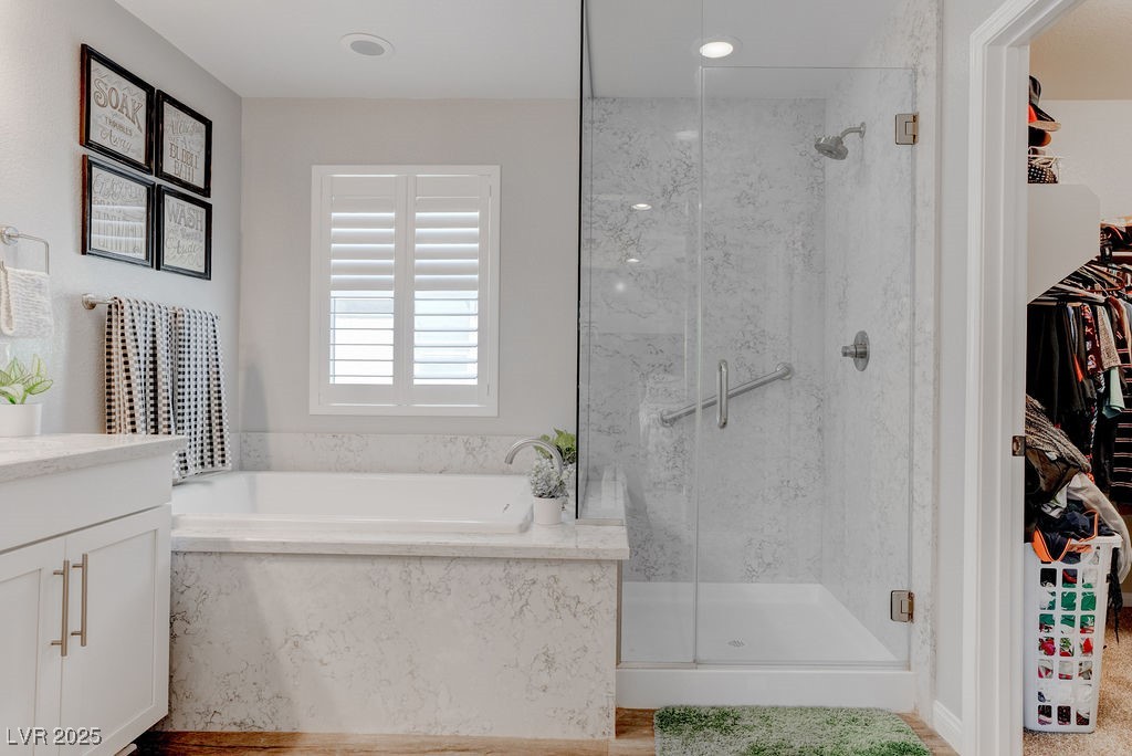 8099 Rams Collide Street Las Vegas, NV 89166 - Photo 51 of 72 Full bath featuring a walk in closet, a garden tub, a marble finish shower, and vanity