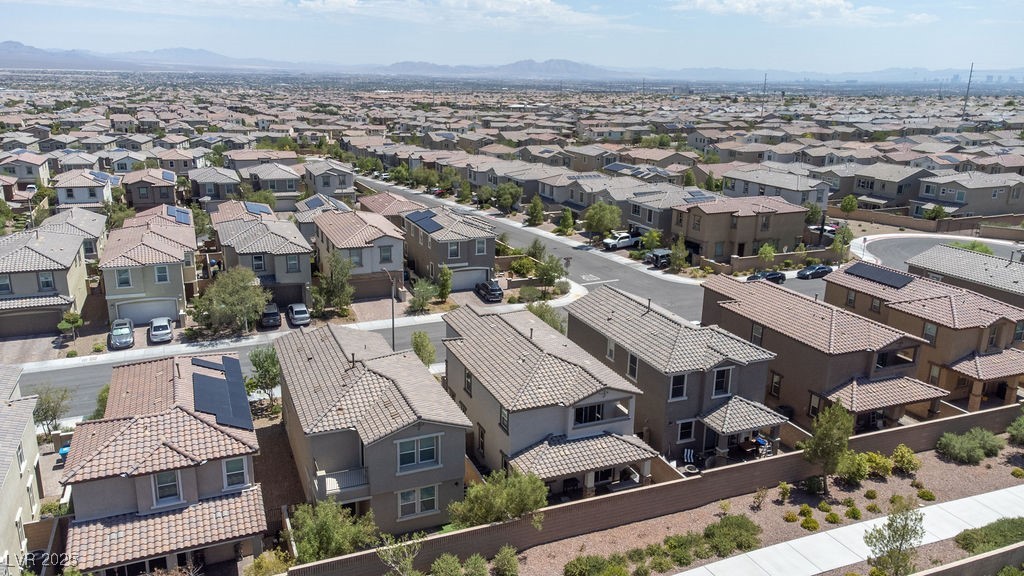 8099 Rams Collide Street Las Vegas, NV 89166 - Photo 59 of 72 Aerial view of residential area with a mountainous background