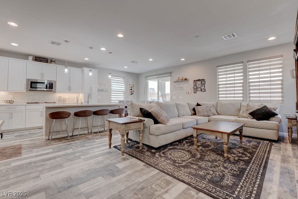 8099 Rams Collide Street Las Vegas, NV 89166 - Photo 6 of 72 Living room featuring recessed lighting and light wood-style flooring