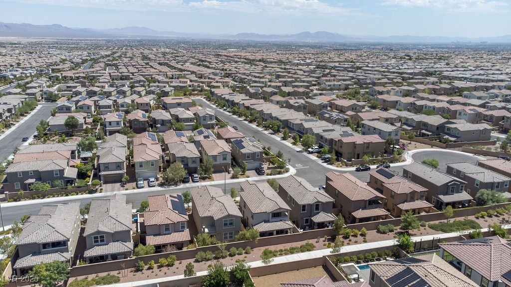 8099 Rams Collide Street Las Vegas, NV 89166 - Photo 63 of 72 Aerial perspective of suburban area featuring a mountainous background
