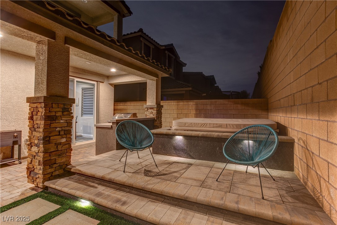 8099 Rams Collide Street Las Vegas, NV 89166 - Photo 68 of 72 Patio at twilight with a patio area and a grill