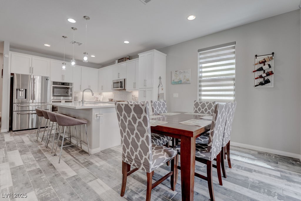 8099 Rams Collide Street Las Vegas, NV 89166 - Photo 8 of 72 Dining area featuring recessed lighting and light wood-style flooring