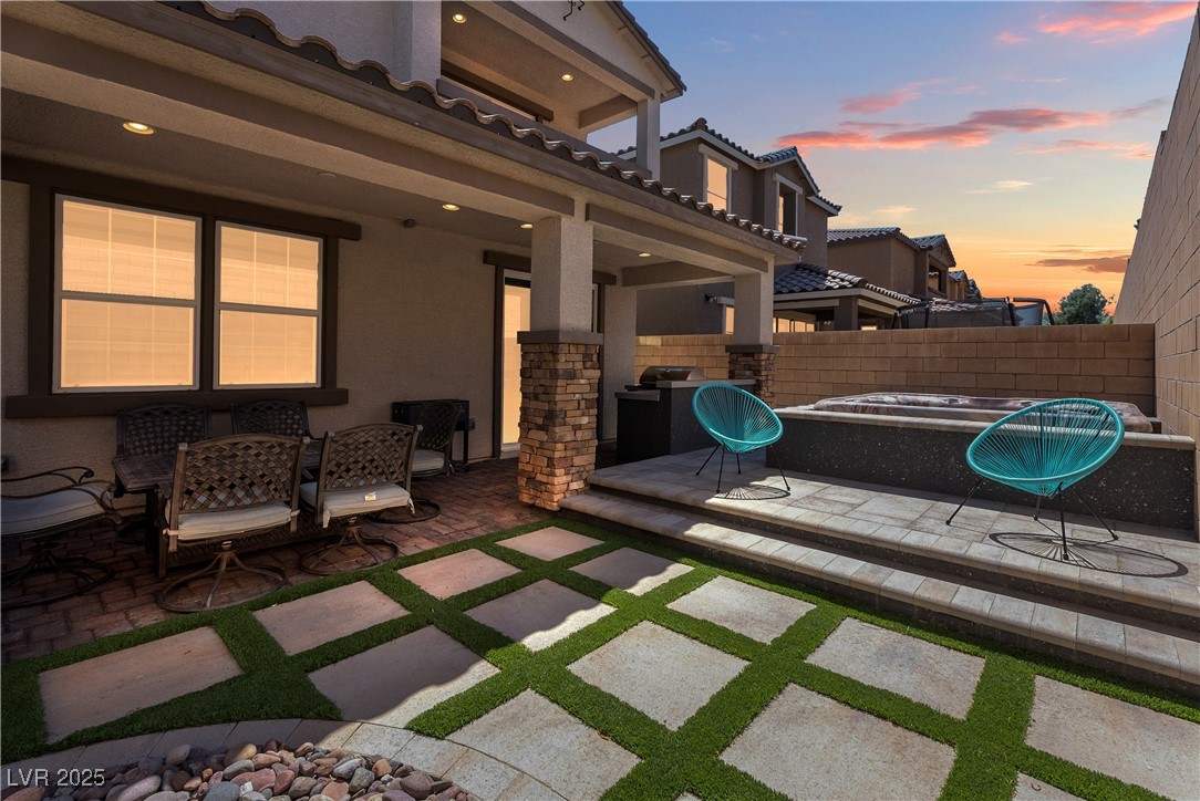 8099 Rams Collide Street Las Vegas, NV 89166 - Photo 9 of 72 Fenced backyard with a patio area and outdoor dining area