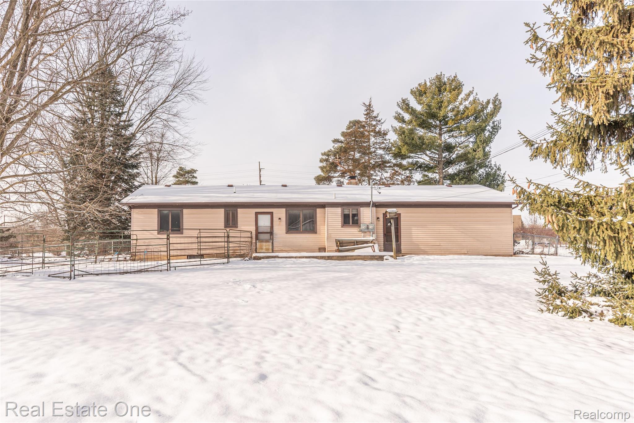 22700 Griswold Road South Lyon, MI 48178 - Photo 4 of 51 Snow covered back of property with a patio