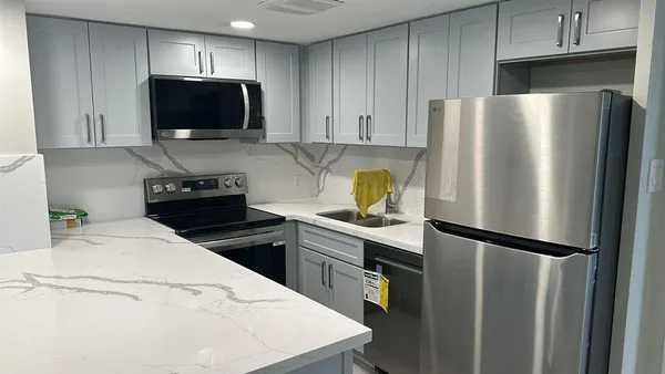 a kitchen with stainless steel appliances a refrigerator stove and microwave