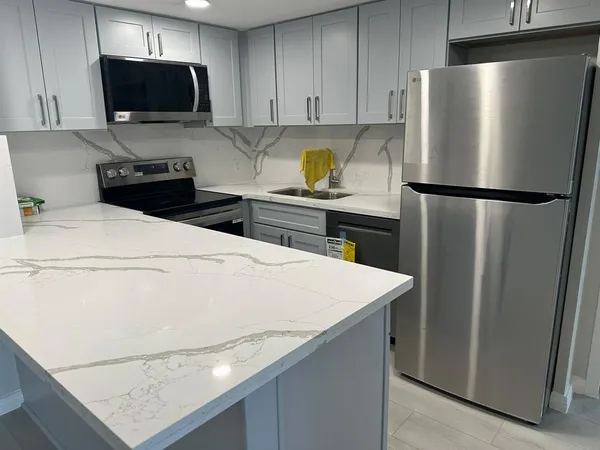 a kitchen with a refrigerator and a stove