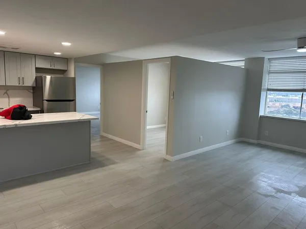 a view of kitchen with stainless steel appliances a refrigerator sink and cabinets