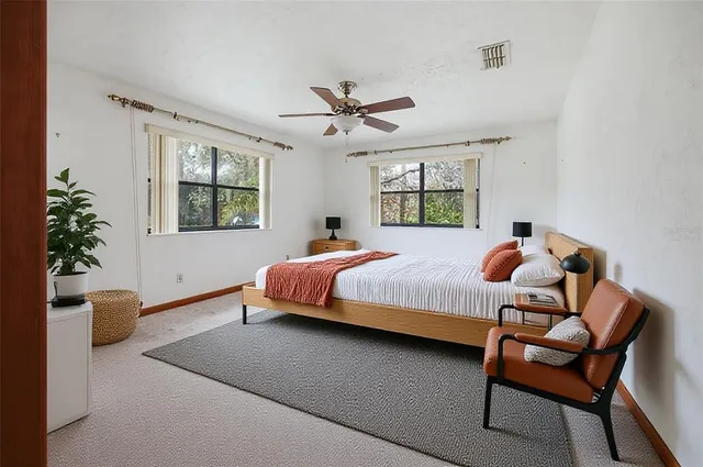 a bedroom with a bed and potted plant
