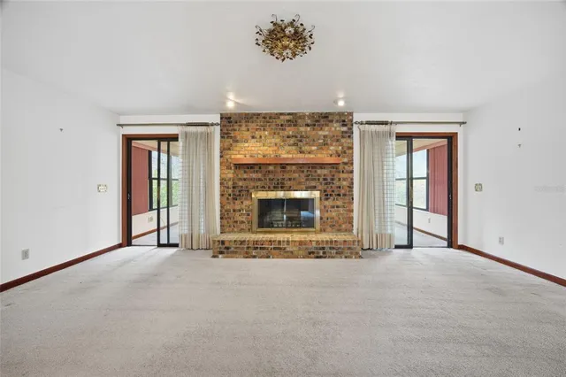 an empty room with a fireplace and window