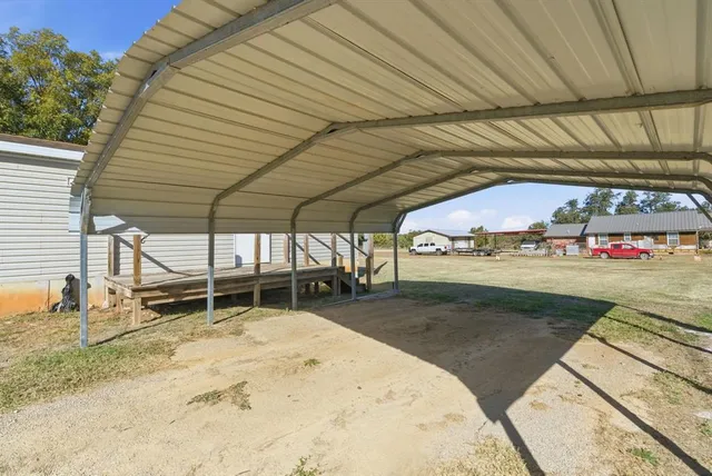 a backyard of a house with basket ball court table and chairs