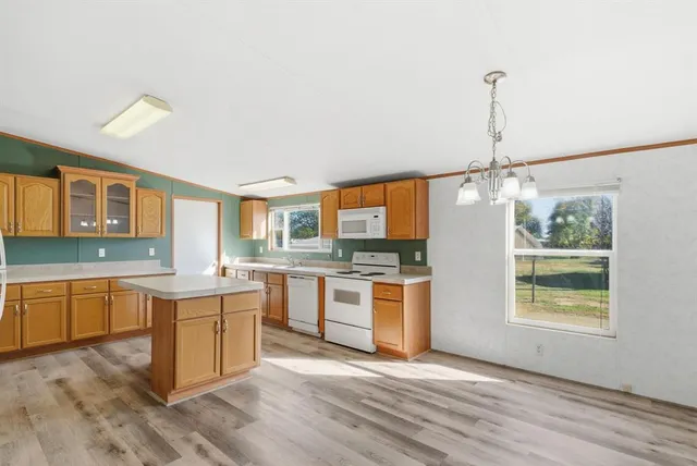 a kitchen with stainless steel appliances granite countertop a sink and stove